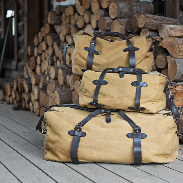 Image showing all three sizes of the tan Filson Duffle bag.